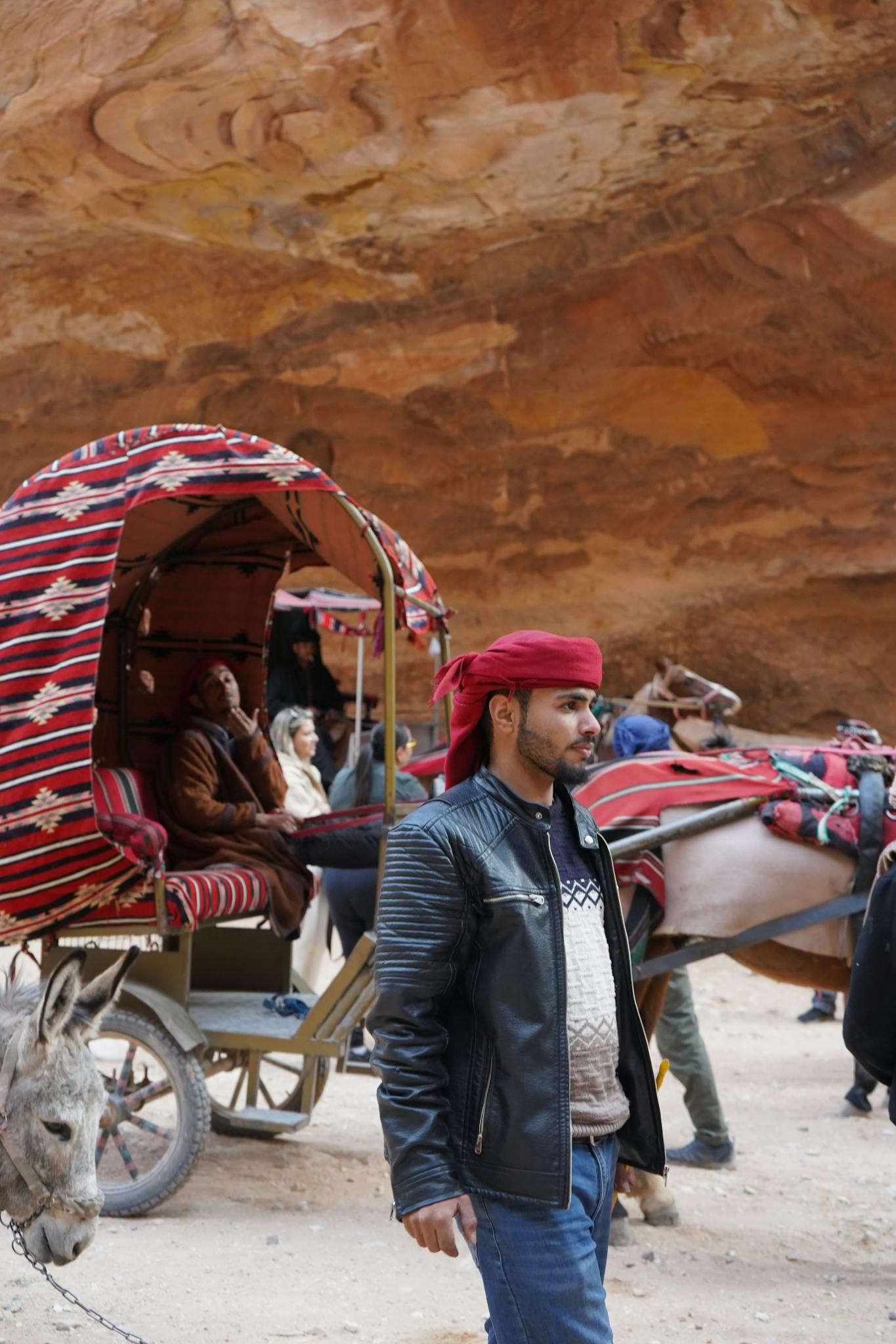Traditional bedouin carriage in a desert landscape with rocky formations.